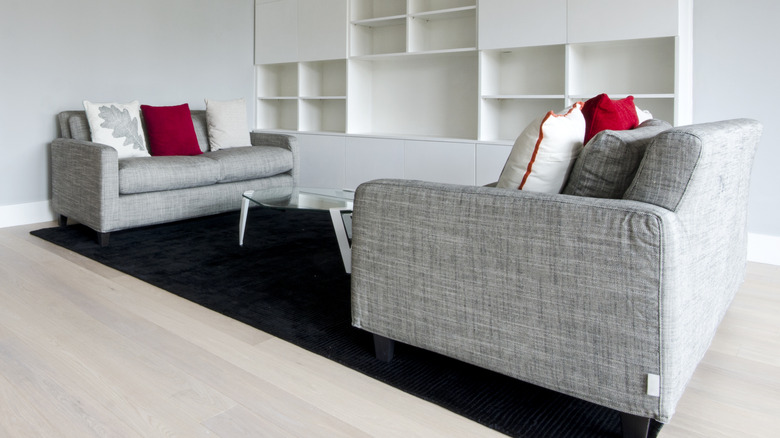 Neutral space with black area rug