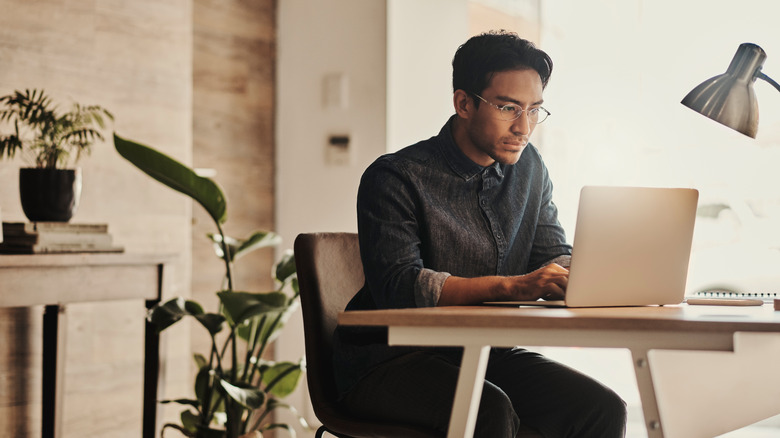 Male person using laptop