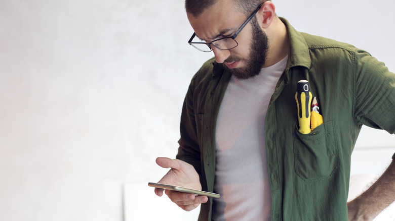 person looking at manual on phone