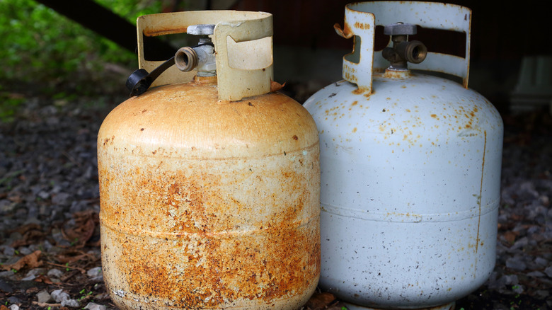 Two old and rusty propane tanks