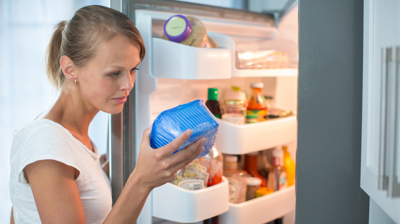 woman looking at expiration dates 