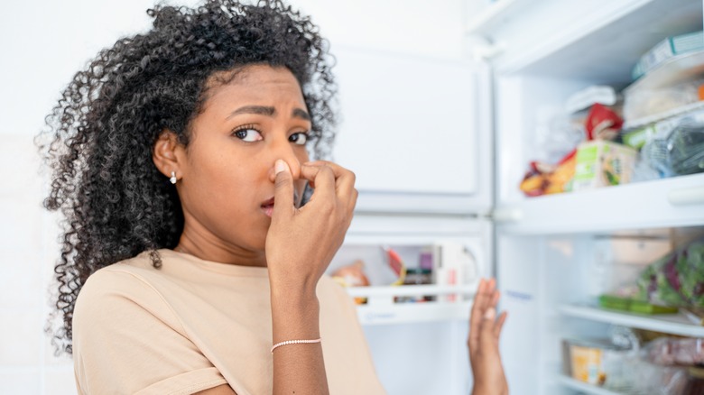 woman and stinky fridge