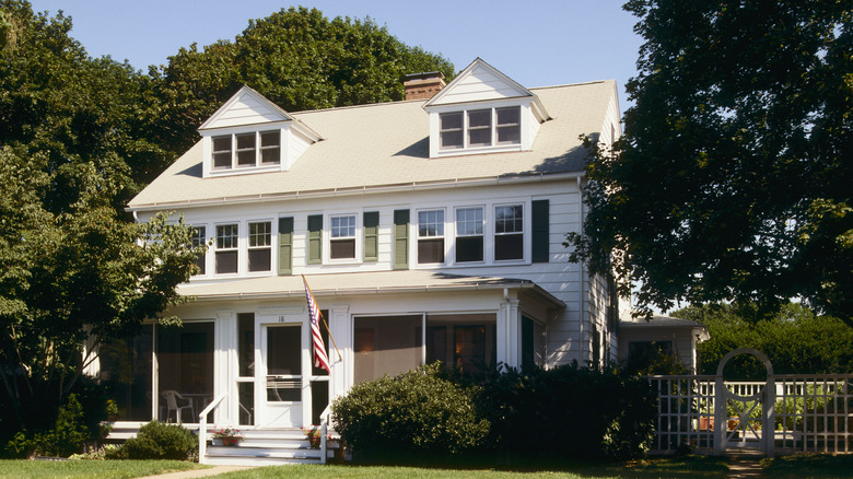 house partially shaded by tree