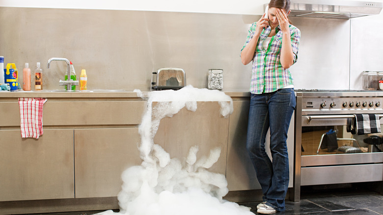 woman with overflowing dishwasher