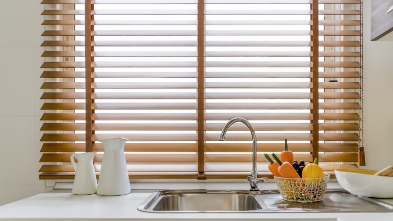 Wood blinds on kitchen window 