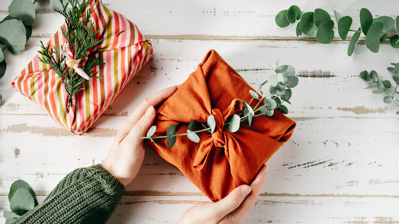 woman holding a gift wrapped in fabric