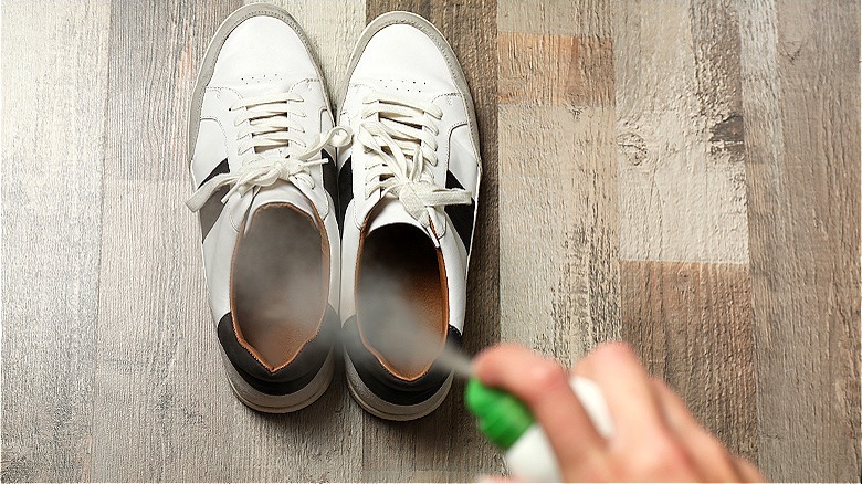 Spraying sneakers with spray bottle 