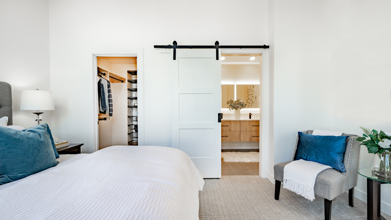 A white barn door in a bedroom