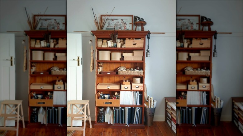 brown wood bookshelf with boxes