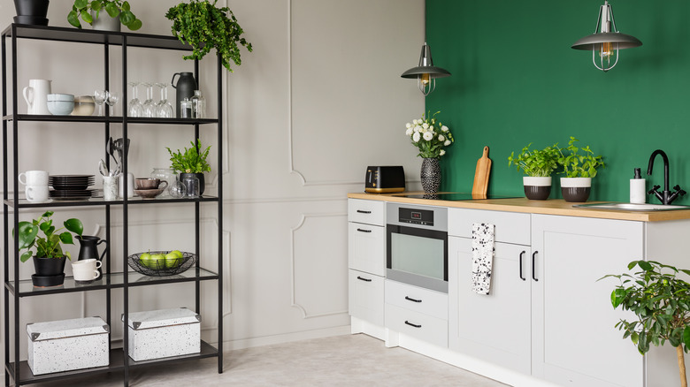 green kitchen with shelf on wall