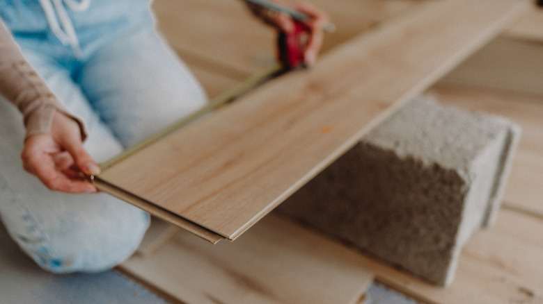 Woman installing flooring