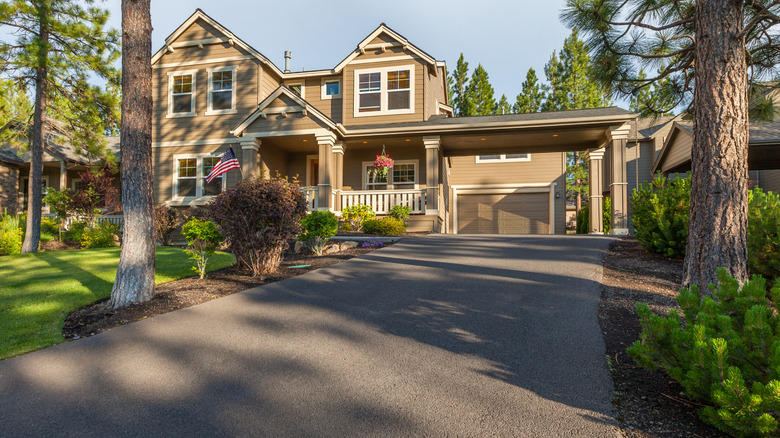 Beautiful house with an asphalt driveway and green lawn