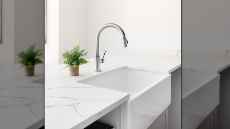 White apron sink and marble countertops