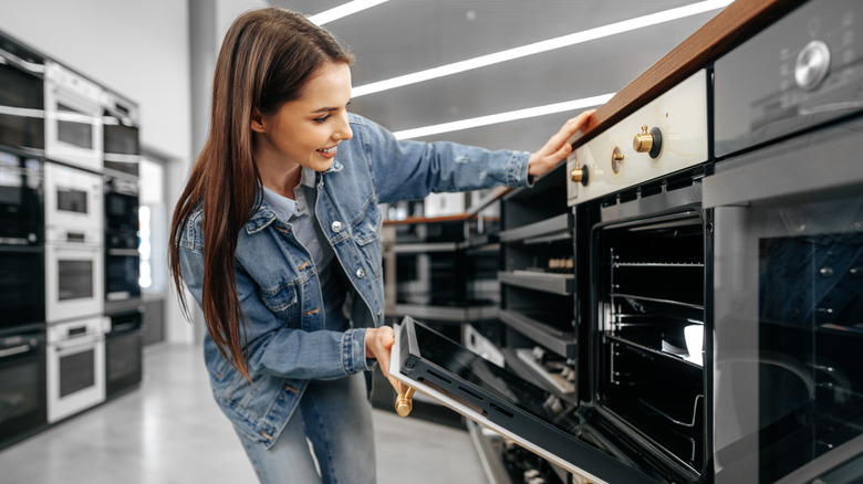 woman opening oven