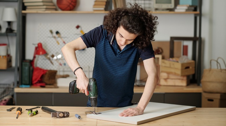 Teen working on cabinet door