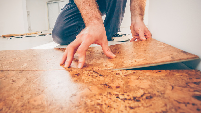 Man installing cork flooring 