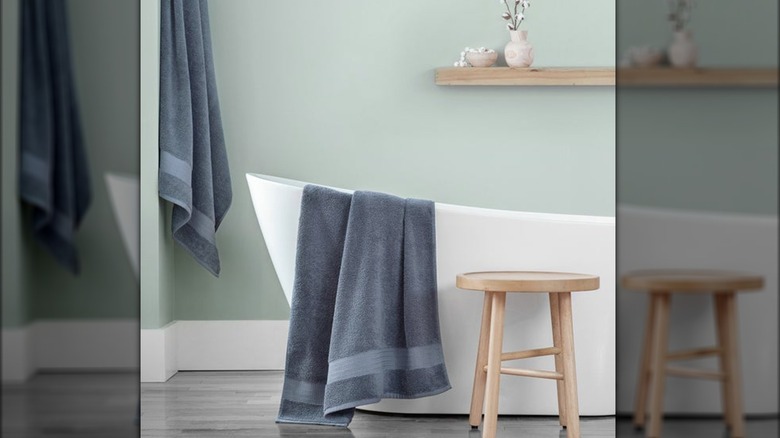 Blue towels hung up in bathroom