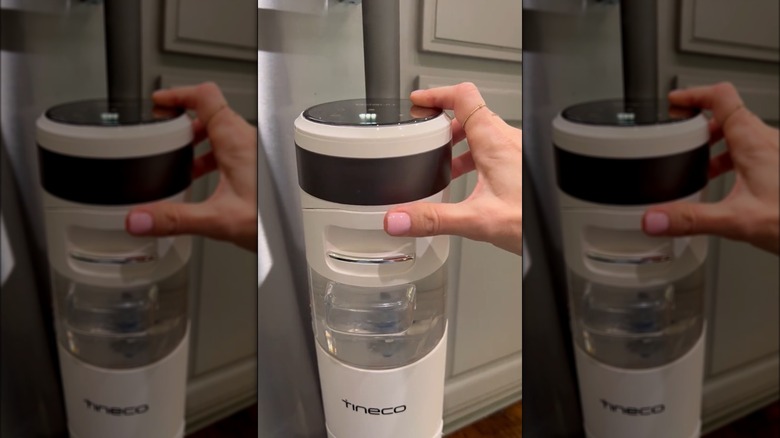 Woman using Tineco wet/dry vacuum