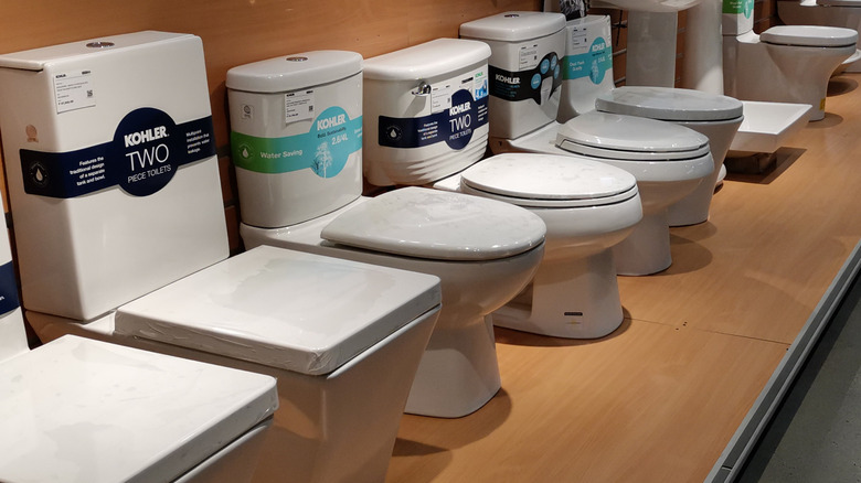 Kohler toilets lined up at a retail store