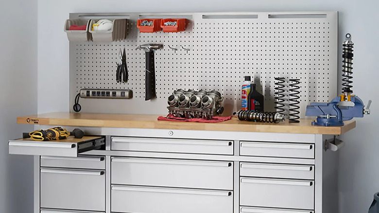 steel workbench with wood counter and pegboard