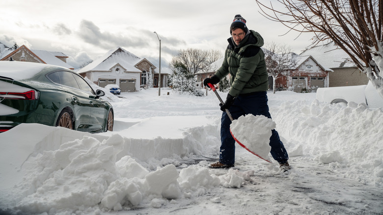 Someone shoveling snow in the driveway