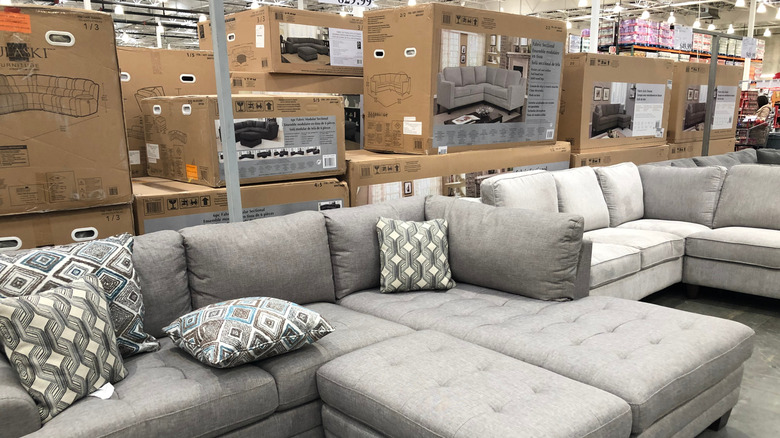 Gray couches in Costco with patterned throw pillows