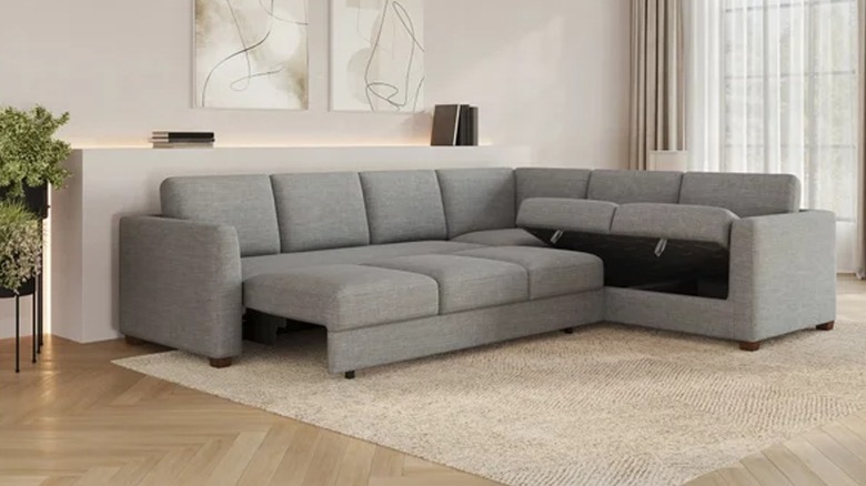 Gray sleeper sofa with storage pulled out from Costco