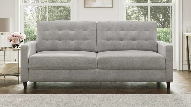 Small gray sleeper sofa from Costco with tufted backrest