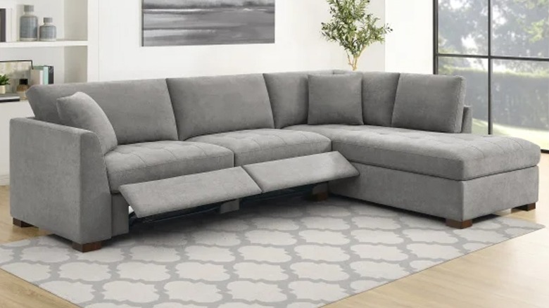 Gray sectional couch with footrests extended in living room