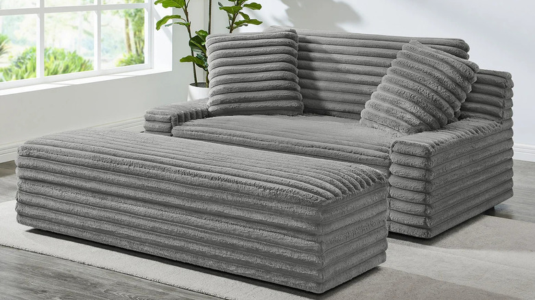 Gray furry corduroy sofa with matching storage ottoman