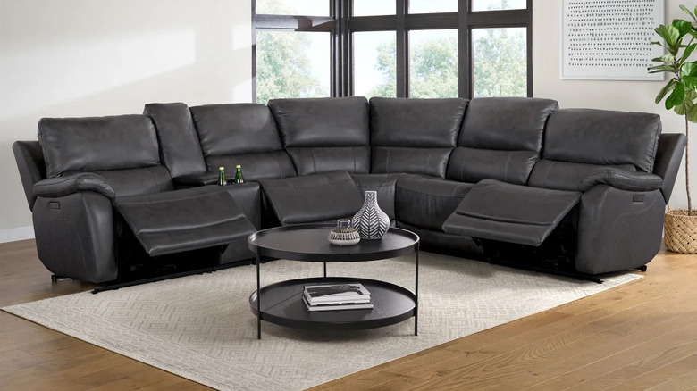 A dark gray leather reclining sectional with USB ports on the side