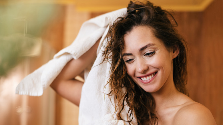 woman smiling using bath towels