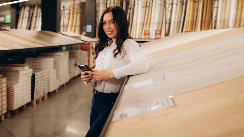 Happy woman choosing flooring