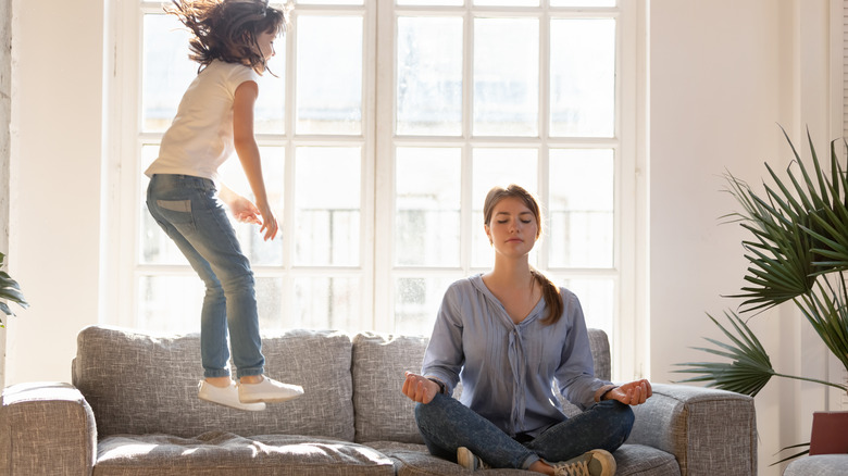 child jumping on a couch