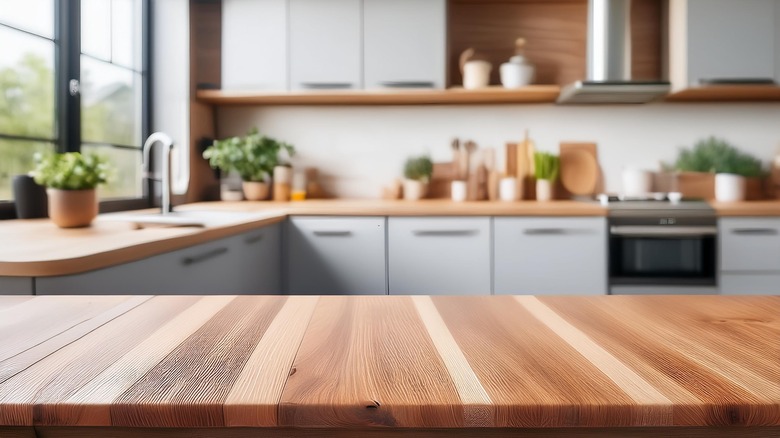 kitchen with wooden countertop in the foreground 