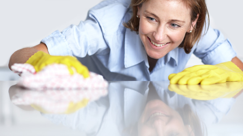 Woman cleaning her kitchen counter