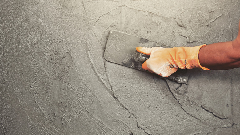 person smoothing concrete countertop