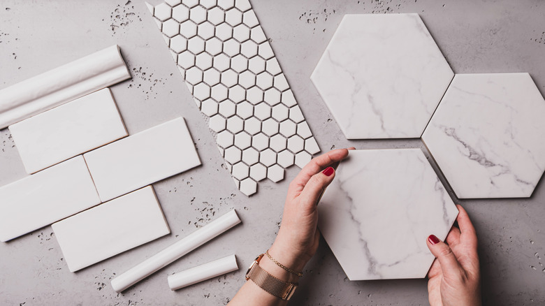 woman selecting tile