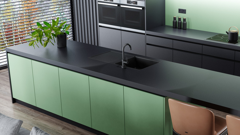 Kitchen with green black cabinets countertops