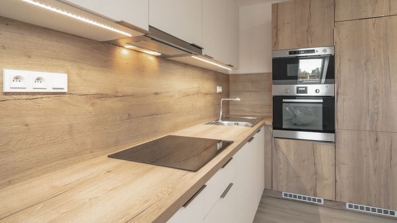 modern kitchen with wooden countertops and backsplash