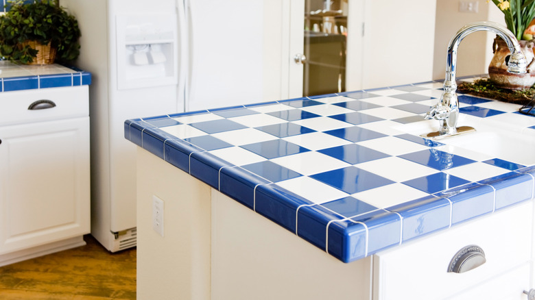 Modern kitchen interior with checkered white and blue tile