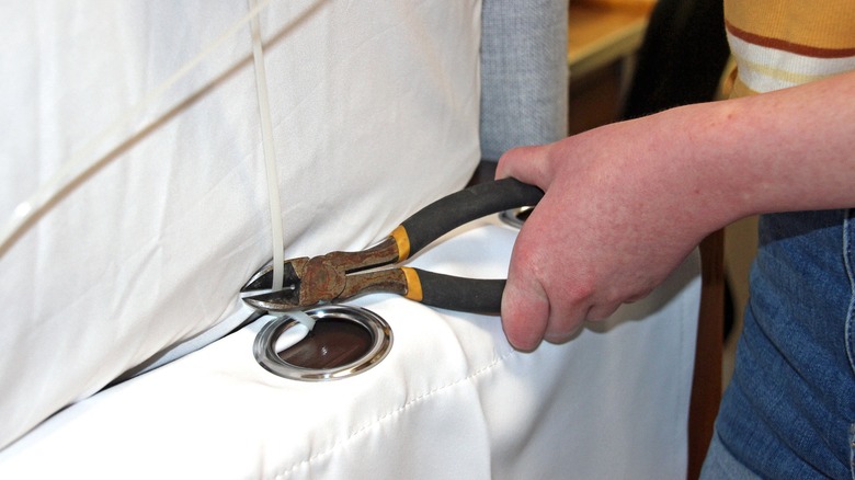 Clipping zip ties on bed skirt