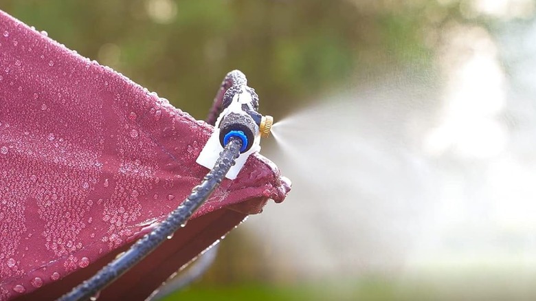 mister spraying water in yard