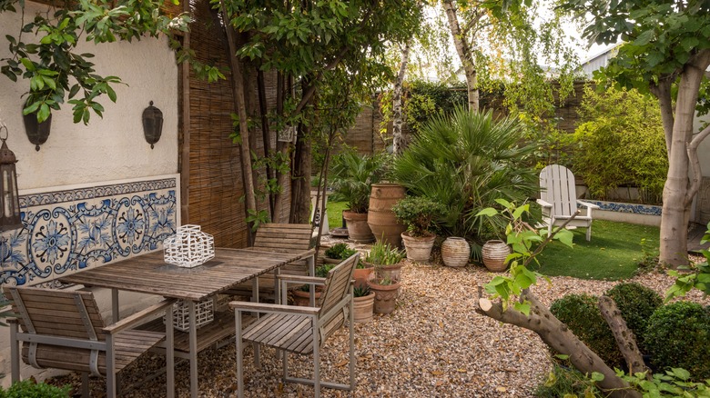 An outdoor patio is surrounded by gravel