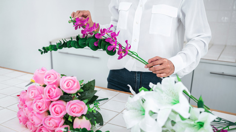 Person working with artificial flowers