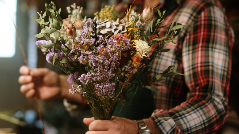 hand holding dried flower bouquet