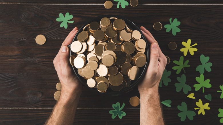 man holding pot of gold