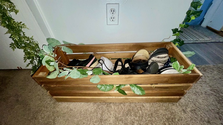 wooden garden box filled with women's shoes