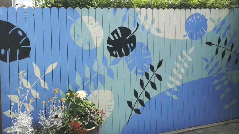 leaf mural painted on fence