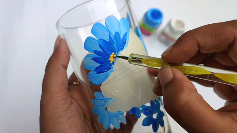 painting blue flower on glass 